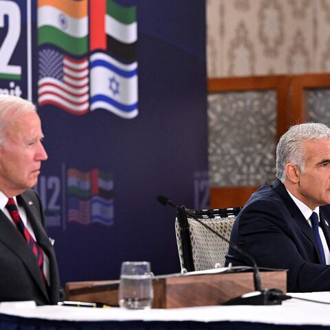 US President Joe Biden (L) and Israel's caretaker Prime Minister Yair Lapid, take part in a virtual meeting with leaders of the I2U2 group, which includes, US, Israel, India, and the United Arab Emirates, at a hotel in Jerusalem, on July 14, 2022. (Photo by MANDEL NGAN / AFP) (Photo by MANDEL NGAN/AFP via Getty Images)