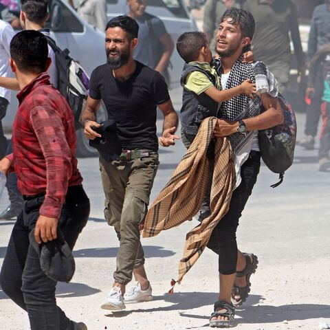 Syrians gather in front of the Bab al-Hawa border crossing with Turkey on Sept. 12, 2022.