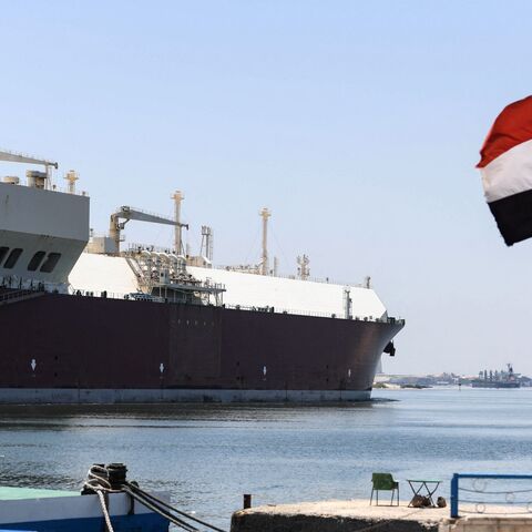An Egyptrian flag is pictured on the shore of the Suez Canal in the northeastern city of Ismailiya, on May 27, 2021. - Talks about compensations with the owner of the container ship Ever Given, that blocked the Suez Canal at the end of March are "at a standstill", Ossama Rabie, the head of the Egyptian authority that runs the Suez Canal said in an interview with AFP. The blocking that lasted six days, cost Egypt between 12 and 15 million USD per day of closure, according to the Suez Canal Authority (SCA). (