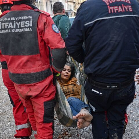 A woman is rescued after surviving the earthquake in the hard-hit Hatay province in Turkey 