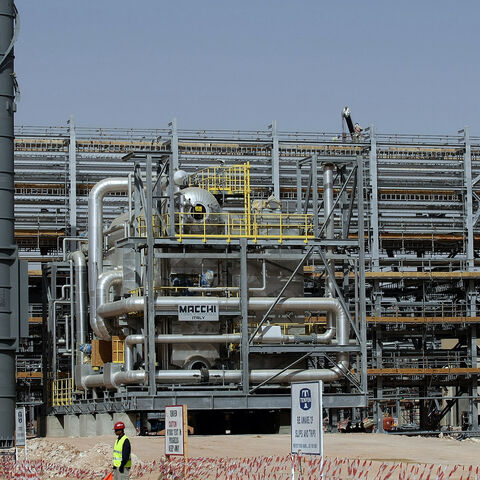 Asian labourers work at the construction site of Saudi Aramco's (the national oil company) Al-Khurais central oil processing facility in the Saudi Arabian desert, 160 kms east of the capital Riyadh, on June 23, 2008. Deep in the Saudi desert, 28,000 Asian workers are racing to get a giant oil processing complex ready to help King Abdullah keep a vow to meet world demand for crude. AFP PHOTO/MARWAN NAAMANI (Photo by MARWAN NAAMANI / AFP) (Photo by MARWAN NAAMANI/AFP via Getty Images)