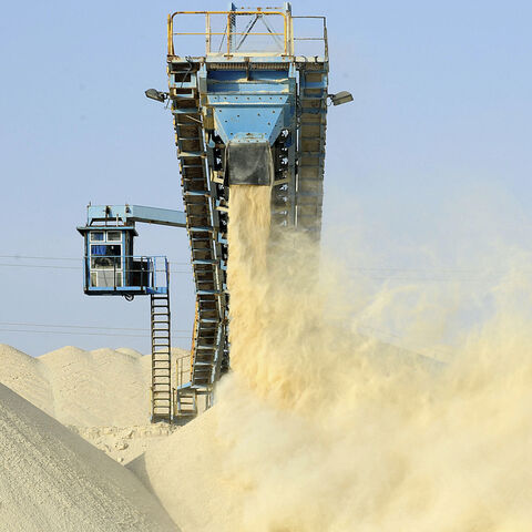 This picture taken on May 13, 2013 shows untreated phosphate being dropped off on a montain at the end of a conveyor belt at the Marca factory of the National Moroccan phosphates company (OCP/public), near Laayoune, the capital of Moroccan-controlled Western Sahara. - As a global leader in the market for phosphate and its derivatives, OCP has been a key player in the international market since its founding in 1920, the worlds largest exporter of phosphate rock and phosphoric acid and one of the worlds large