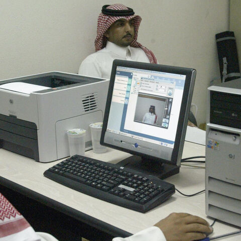  A Saudi man has his picture taken for his election ID card as registration opened 23 November 2004, for the kingdom's first municipal elections, to be held in February 2005. The first round of the elections, in which women are barred from voting, is the first of the three-stage process of choosing half the members of 178 municipal councils, the other half of which are named by the government, in a drive to introduce limited reforms which Riyadh insists must be tailored to Saudi specifications and not neces