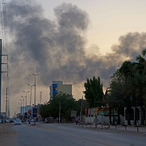 Smoke billows above residential buildings in east Khartoum as fighting in Sudan raged for a second day