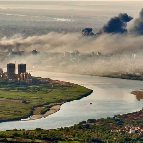 This video grab taken from AFPTV video footage on April 19, 2023, shows an aerial view of black smoke covering the sky above the capital Khartoum