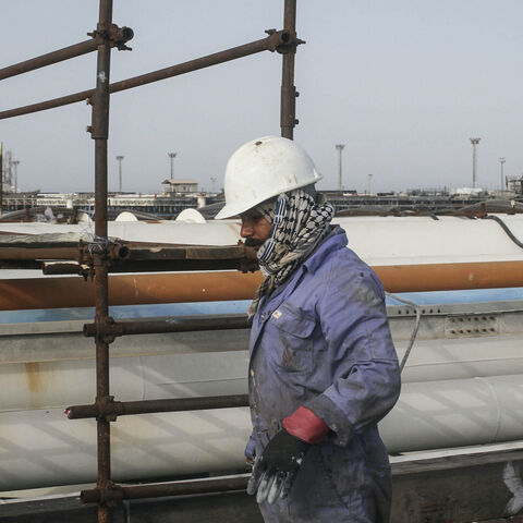 An Iranian man works at an oil facility in the Khark Island, on the shore of the Gulf, on February 23, 2016. - Iran's Oil Minister Bijan Namdar Zanganeh dismissed an output freeze deal between the world's top two producers Saudi Arabia and Russia as "a joke", the ISNA news agency reported. (Photo by AFP) (Photo by STR/AFP via Getty Images)