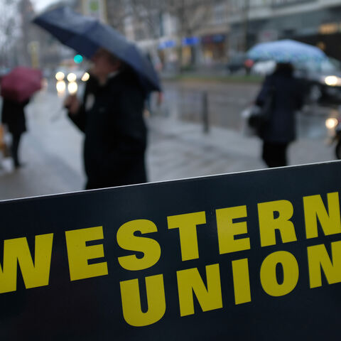A sign advertises the money transfer service Western Union on January 11, 2018 in Berlin, Germany. Much of the German financial services, consumer goods and foodstuffs economy is dominated by nationwide chains and brands. (Photo by Sean Gallup/Getty Images)