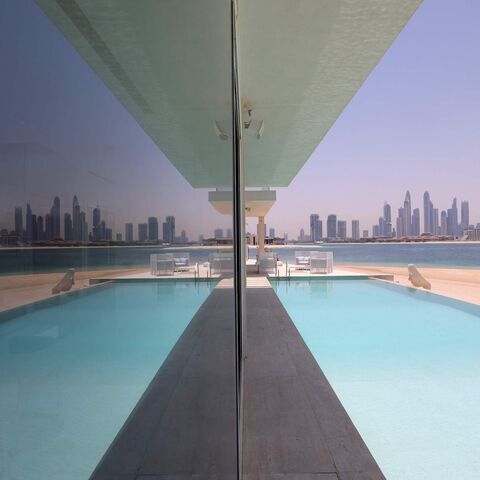 This picture shows the swimming pool of a luxury villa for sale on one of the Palm Jumeirah man-made island, on the coast of the Gulf emirate of Dubai, on May 19, 2021. - Dubais property market is powering out of a six-year malaise as "lockdown dodgers" and wealthy international investors drive a buying frenzy that is breaking records and fuelling an economic recovery. Luxury villas are the hottest segment in the market, with European buyers in particular seeking homes on Dubais signature Palm Jumeirah man-