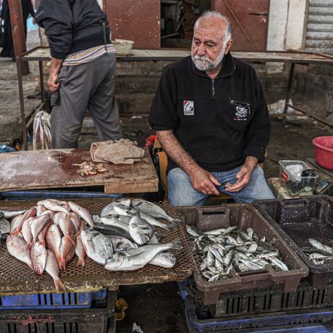 A picture taken on April 29, 2023, shows a Palestinian fish vendor at a market in Gaza City. 