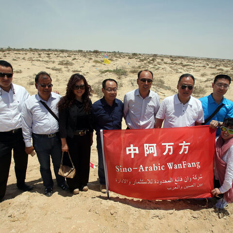 Chinese investors pose for a picture in the land where an industrial city, including an oil refinery, is due to be built following an economic agreement, in the port town of Duqm on May 24, 2016 . Chinese investors signed a deal with Oman's government to establish an industrial city, including an oil refinery, in the port town of Duqm, both sides said in a joint statement. The agreement signed during the ceremony in Muscat would open way for investments worth $10.7 billion by 2022 to finance industrial proj