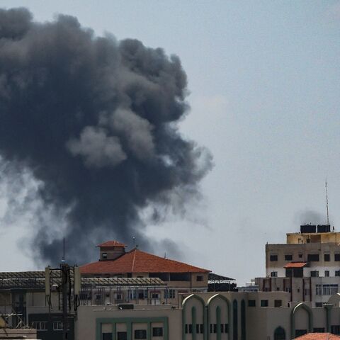 Smoke rises above buildings in Gaza City after during an Israeli air strike on May 13