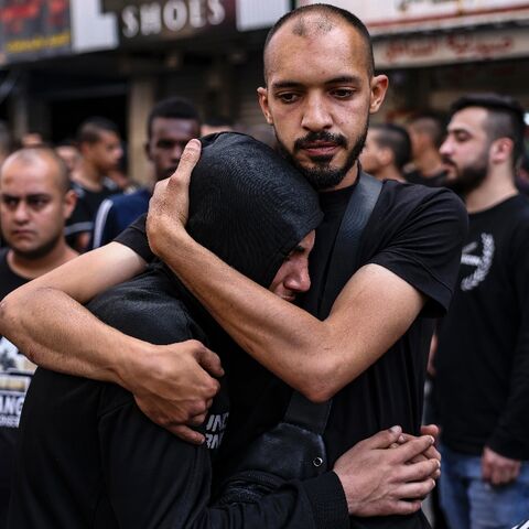 People mourn the death of two Palestinians killed by Israeli troops in a morning raid on Tulkarm in the occupied West Bank