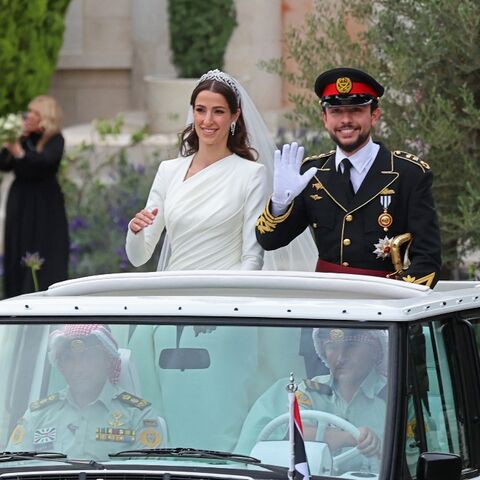 Jordan's Crown Prince Hussein and his Saudi wife Rajwa Al Seif wave as they leave the Zahran Palace in Amman