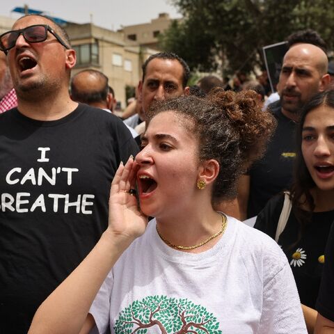 Demonstrators shout slogans as they protest against the killing of five Arab Israelis in the village of Yafia, west of Nazareth