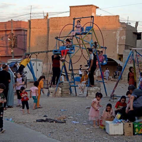Iraqi children gather at a playground in the old city of Mosul on June 30, 2023 during the Muslim feast of Eid al-Adha. (Photo by Zaid AL-OBEIDI / AFP) (Photo by ZAID AL-OBEIDI/AFP via Getty Images)