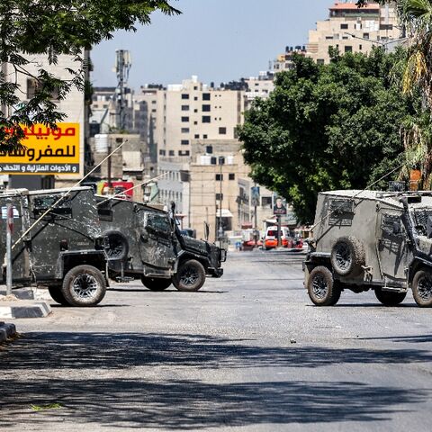 Israeli army vehicles block off a road during a deadly raid on a Palestinian refugee camp in the flashpoint West Bank city of Nablus