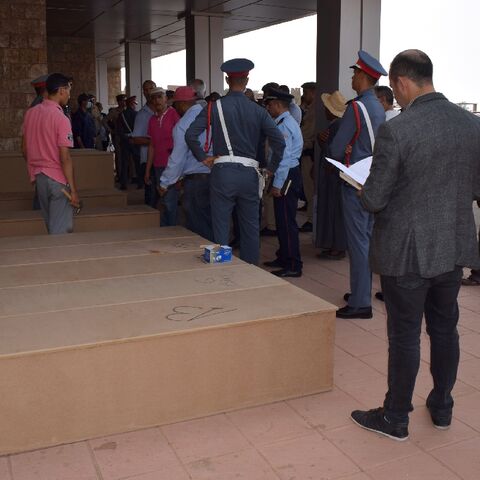 Families gather outside the morgue in the town of Demnate, in Morocco's central province of Azilal