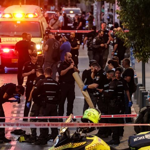 Israeli police gather evidence from the scene of a shooting in commercial hub Tel Aviv which criticially wounded an Israeli