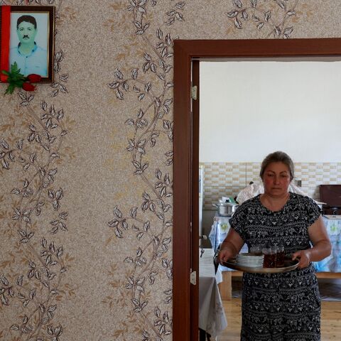 Widow Nazakat Valiyeva, an Azeri refugee from Nagorno-Karabakh, with a picture of her husband who was killed by shelling in 2020