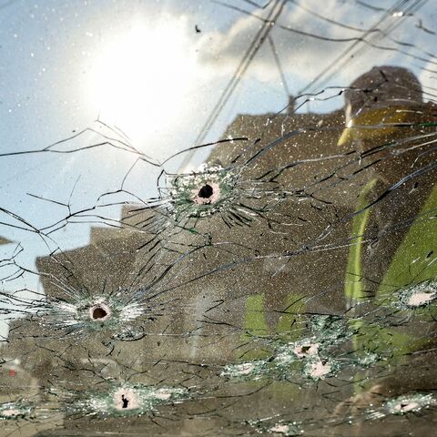 A Palestinian inspects the bullet-holed windscreen of a vehicle after a raid by Israeli troops on Jenin refugee camp in the occupied West Bank