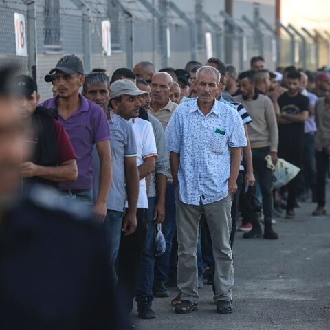 Palestinian workers gather at the Erez crossing between Israel and the Gaza Strip