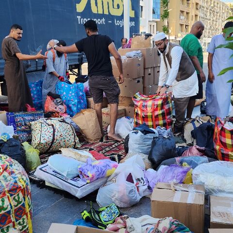 Libyans donate clothes and blankets at a collection point in the capital Tripoli for transport across the nation's political divide to the flood-hit city of Derna