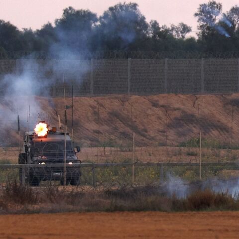 Israeli soldiers fire tear gas towards Palestinian protesters during clashes along the Gaza border