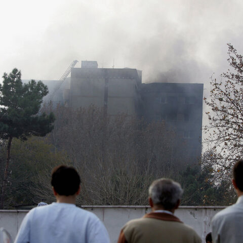 Rescue teams attend to the scene of devastation after an Iranian military plane crashed into a residential building in a heavily built-up suburb on December 6, 2005 in Tehran, Iran. A huge explosion was reported as the plane, carrying 94 people, crashed into a 10-storey block killing all on board. Many deaths are also feared on the ground after the C-130 plane encountered a technical problem shortly after take-off from Mehrabad airport. (Photo by Hossein/Getty Images)