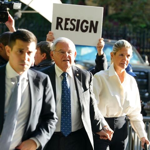 A protester outside a New York court calls on US Senator Bob Menendez to resign over corruption charges September 27, 2023