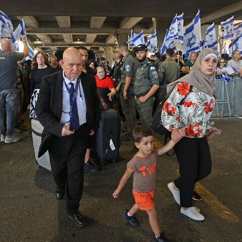 People leave Israel's Ben Gurion Airport near Lod as anti-government demonstrators rally in July 2023
