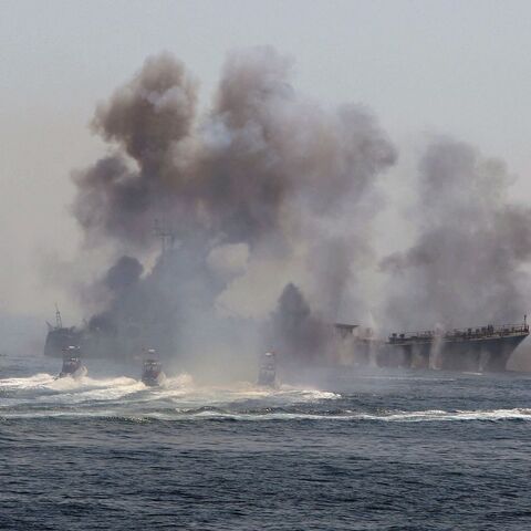 Iran's elite Revolutionary Guard boats attack a naval vessel during a three-day military drill in the Gulf on April 22, 2010.
