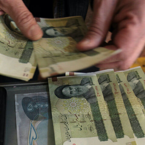 TO GO WITH AFP STORY BY SALAM FARAJ An Iraqi money dealer counts Iranian rial banknotes bearing a portrait of the late founder of the Islamic Republic of Iran, Ayatollah Ruhollah Khomeini, at an exchange office in Baghdad on February 3, 2012. Tens of thousands of Iranian visitors have been finding difficulty in using the Iranian currency in Iraq due to a depreciation of the rial against the dollar. AFP PHOTO/ ALI AL-SAADI (Photo credit should read ALI AL-SAADI/AFP/GettyImages)