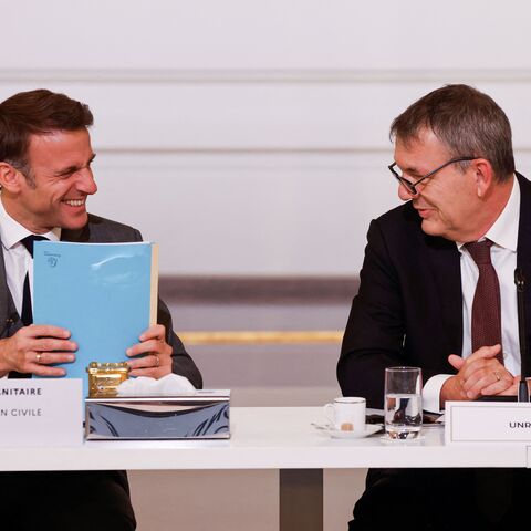 French President Emmanuel Macron (L) speaks with Commissioner general of UNRWA Philippe Lazzarini during an international humanitary conference for civilians in Gaza, at the Elysee Presidential Palace, in Paris, on November 9, 2023. Thousands of civilians, both Palestinians and Israelis, have died since October 7, 2023, after Palestinian Hamas militants based in the Gaza Strip entered southern Israel in an unprecedented attack triggering a war declared by Israel on Hamas with retaliatory bombings on Gaza. (
