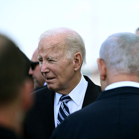 Israel Prime Minister Benjamin Netanyahu (back L) greets US President Joe Biden upon his arrival at Tel Aviv's Ben Gurion airport on October 18, 2023, amid the ongoing battles between Israel and the Palestinian group Hamas. Biden landed in Israel on October 18, on a solidarity visit following Hamas attacks that have led to major Israeli reprisals. (Photo by Brendan Smialowski / AFP) (Photo by BRENDAN SMIALOWSKI/AFP via Getty Images)
