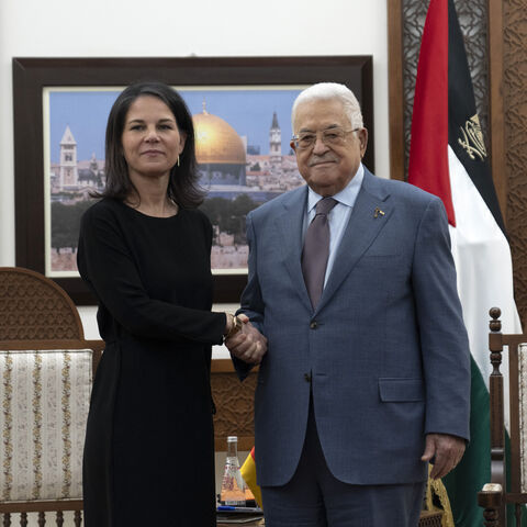 Palestinian President Mahmud Abbas (R) receives German Foreign Minister Annalena Baerbock at his office in the West Bank city of Ramallah on March 25, 2024. (Photo by Nasser Nasser / POOL / AFP) (Photo by NASSER NASSER/POOL/AFP via Getty Images)