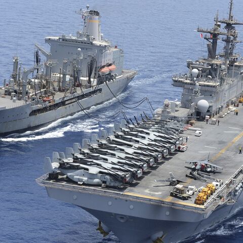The Military Sealift Command fleet replenishment oiler USNS Laramie (T-AO 203) and the amphibious assault ship USS Kearsarge (LHD 3) conduct a replenishment-at-sea.
