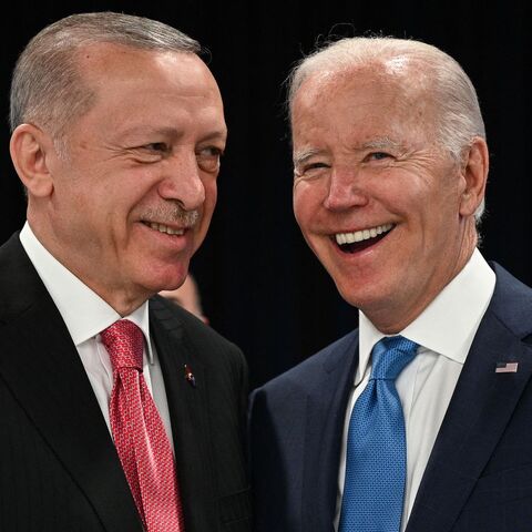 Turkey's President Recep Tayyip Erdogan (L) and US President Joe Biden shake hands at the start of the first plenary session of the NATO summit at the Ifema congress centre in Madrid, on June 29, 2022. 