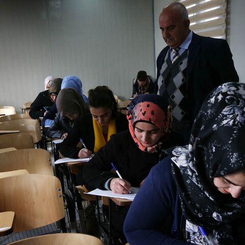 Iraqi displaced students, who fled clashes between pro-government forces and Islamic State (IS) group jihadists, sit in a classroom at the Hamdaniya University for internally displaced people on Jan. 31, 2016, in Arbil, in Iraq's autonomous Kurdish region.