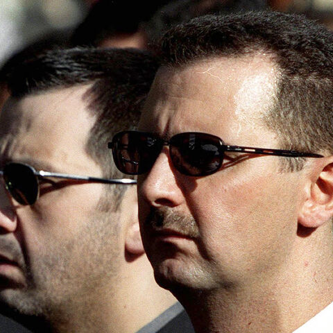 TO GO WITH STORY BY NATACHA YAZBECK (FILES) A picture dated June 13, 2003 shows Syrian President Bashar al-Assad and his brother Maher (L) attending their father's funeral in Damascus on June 13, 2000. As Bashar al-Assad's regime fights to stay in power, one man has emerged as the symbol of the dynasty's brutal military might -- the president's feared younger brother Maher. AFP PHOTO/RAMZI HAIDAR / AFP PHOTO / RAMZI HAIDAR (Photo credit should read RAMZI HAIDAR/AFP via Getty Images)