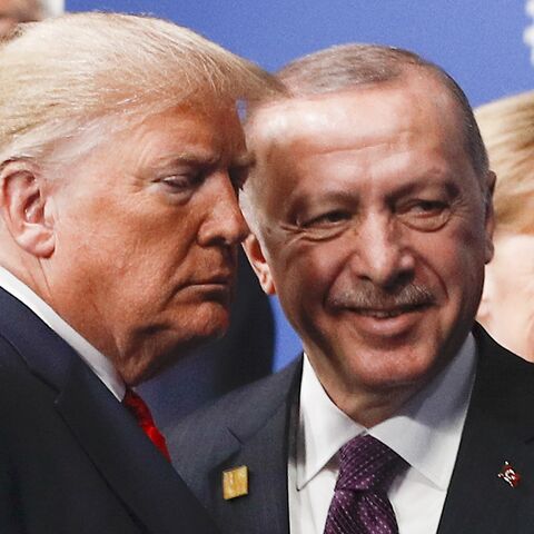US President Donald Trump (L) and Turkey's President Recep Tayyip Erdogan (R) leave the stage after the family photo to head to the plenary session at the NATO summit at the Grove hotel in Watford, northeast of London.