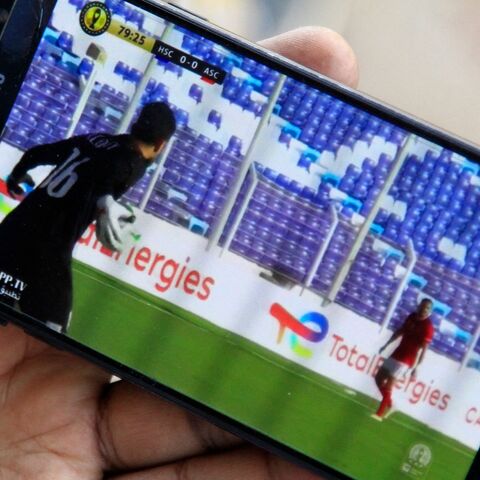 A supporter of Sudanese football team al-Hilal Omdurman watches on a phone a stream of his team's CAF Champions League group stage match.