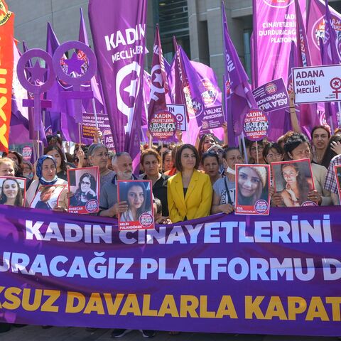 Women's rights activists and relatives of victims of feminicide wait outside the Istanbul court ahead of a hearing on June 1, 2022. 
