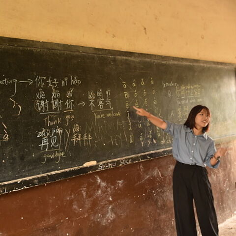 Mandarin language teacher Liu Mei gestures a the blackboard at the Confucius Institute in Sierra Leone during a class for students of the Fourah Bay College Secondary School in Freetown on October 15, 2024. The Chinese language and martial arts teachings are becoming popular amongst school children in several school institutions in Freetown and at the Fourah Bay College Secondary School since it was established in the country in 2012 to promote people to people traditional and cultural exchanges and for dee