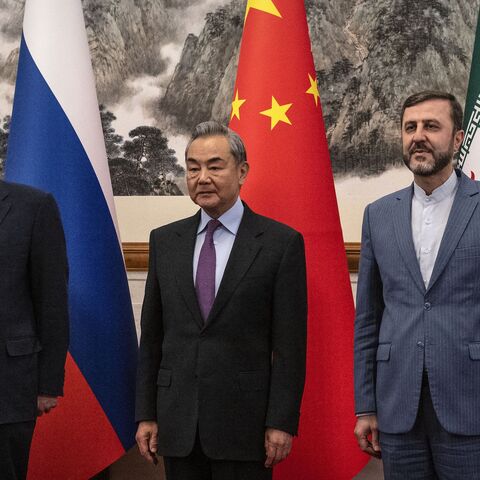 China's Foreign Minister Wang Yi (C) welcomes Russia's Deputy Foreign Minister Sergey Ryabkov (L) and Iran's Deputy Foreign Minister Kazeem Gharibabadi.