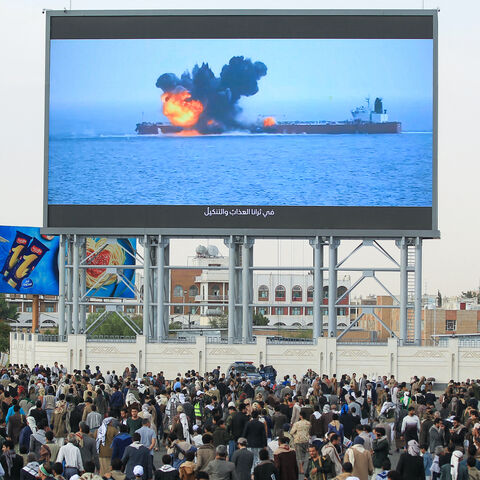 Images of a fireball exploding on a cargo ship are shown on a giant screen during a protest called for by Yemen's rebel Houthi movement in Sanaa on March 17, 2025. 