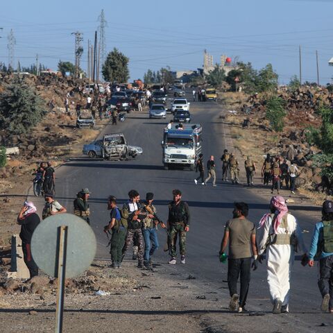 Bedouin and tribal fighters deploy at the western entrance of Syria's Druze heartland of Suwayda on July 18, 2025. 