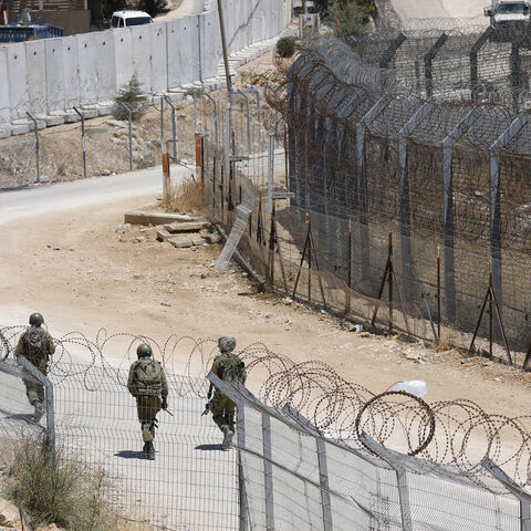Israeli troops patrol the border fence with Syria near the Druze village of Majdal Shams in the Israel-annexed Golan Heights, July 23, 2025.