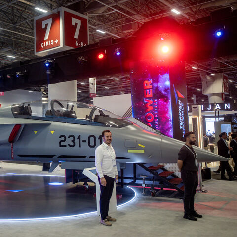 People pose for photographs in front of a Turkish Hurjet at Turkey's 17th International Defense Industry Fair (IDEF) on July 24, 2025 in Istanbul, Turkey.  