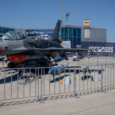 People look at a Turkish fighter jet on display at Turkey's 17th International Defense Industry Fair (IDEF) in Istanbul on July 25, 2025, in Istanbul, Turkey. 