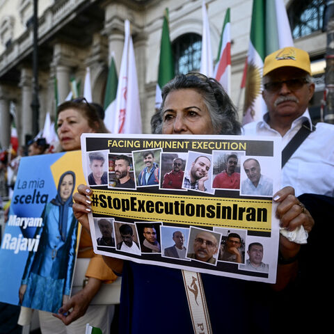 Protesters hold placard against executions in Iran during a rally against the Iranian regime in Rome on July 30, 2025. 